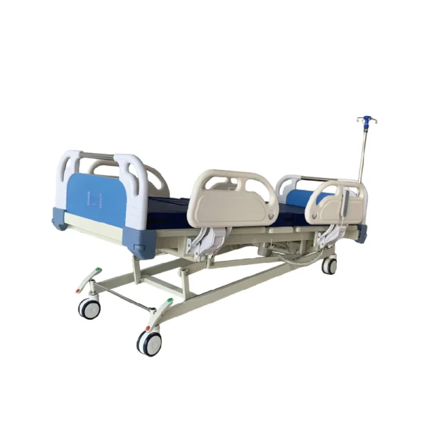 Close-up of medical bed safety: locked siderails, CPR emergency button, dual IV poles, and battery backup panel. Trendelenburg position shown.